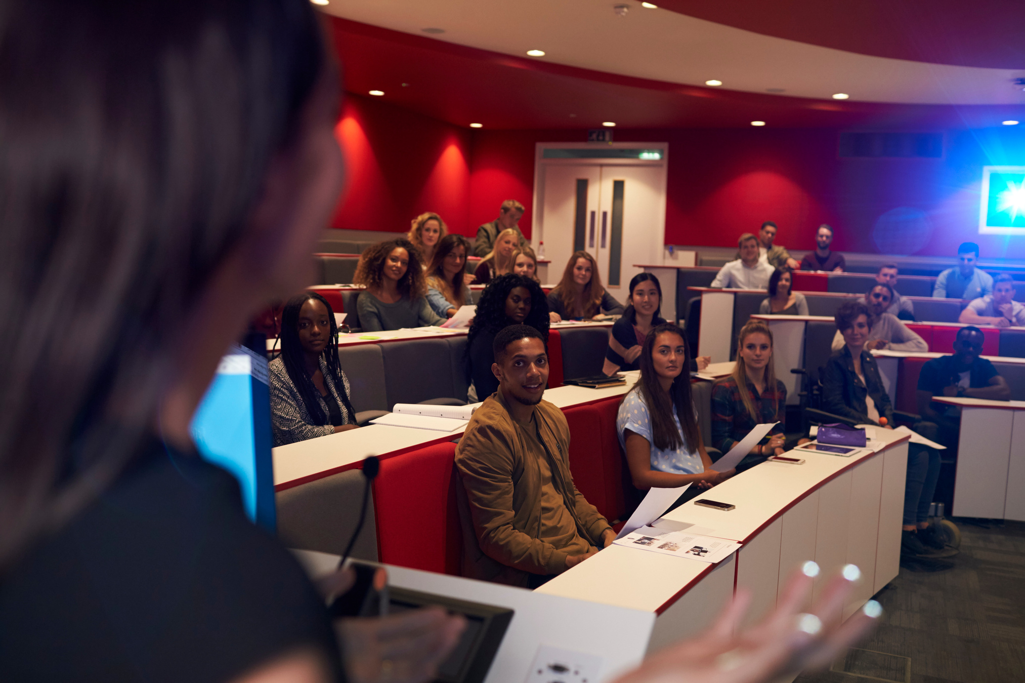 Woman Lecturing Students in Lecture Theatre, Focus Midground